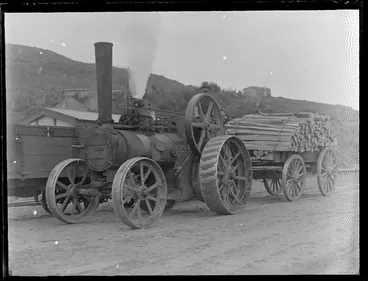 Image: Unidentified man driving a steam tractor pulling a wagon of fence posts, Kakahi Settlement sawmill, Manawatu-Whanganui Region