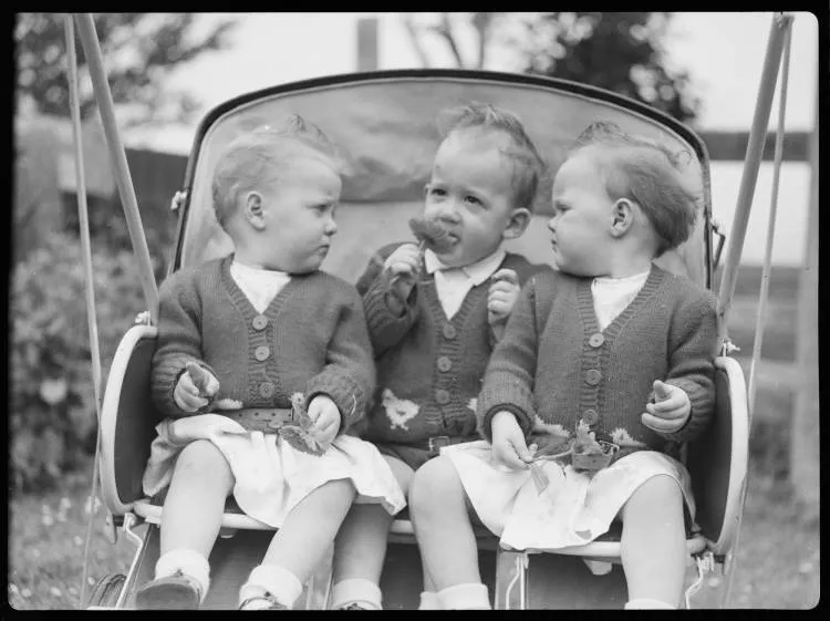 Triplets in a pushchair, 1947