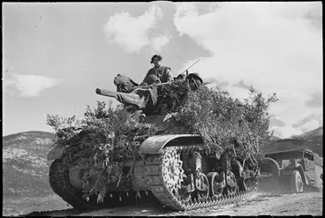 Image: Camouflaged tank moving forward in readiness for armoured assault on Cassino, Italy, World War II - Photograph taken by George Kaye