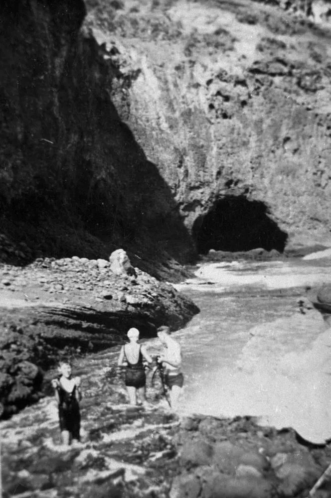Bathers near cave, Bethells Beach