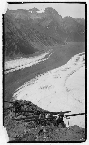 Image: Carrying timber up the Haast Ridge for building Haast hut