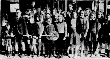 Image: Children of'Newtown School receiving instruction in street crossing '"** and traffic problems under the direction of one of the traffic monitors. (Evening Post, 26 July 1945)