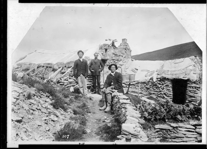 Reverend George Hunter McNeur and two Chinese men outside hut