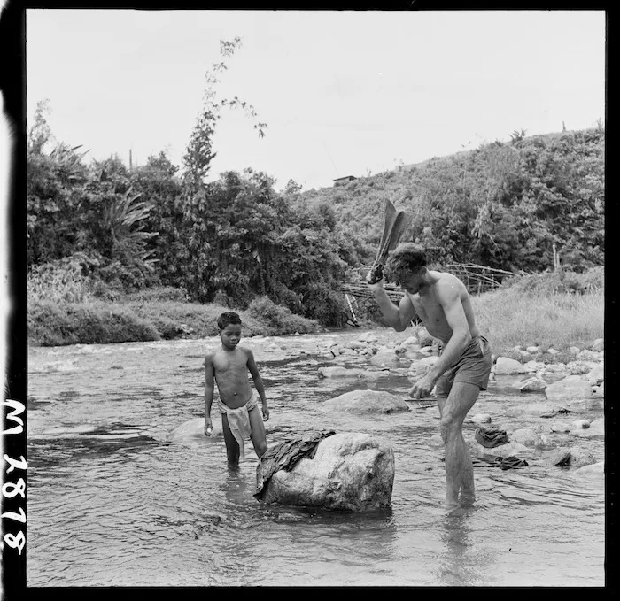 New Zealand soldier Patrick Power washing his clothes in Ber River, Malaya, during the Malayan Emergency