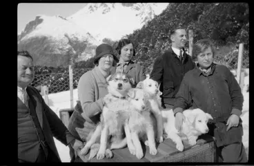 Image: Group of people, with huskies sitting on kennel, Mount Cook area