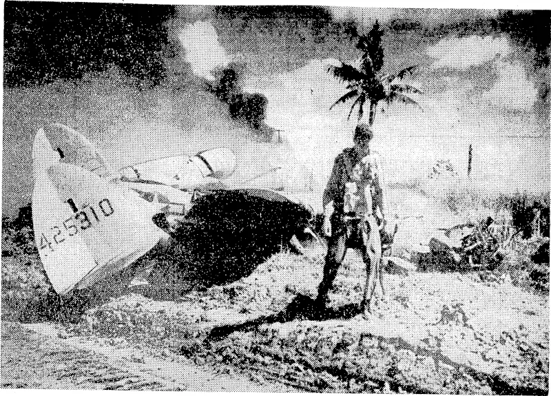 An- American fighter pilot ivalking from his P3B unharmed a few seconds after making a crash landing. He was shot down in flames by a Japanese Zero over Mindoro Island, in the Philippines. (Evening Post, 15 January 1945)