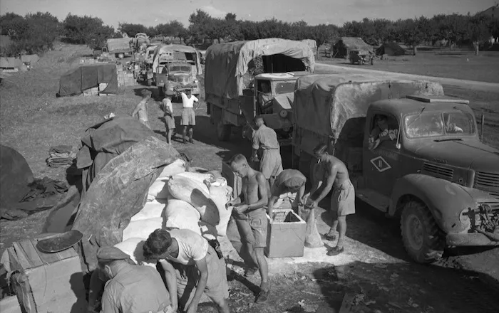 Soldiers measuring out flour at the 2nd New Zealand Division Supply point, near Ancona, Italy