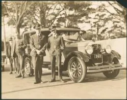 Charles Ulm, front left, and Charles Kingsford-Smith, on right, in front of a Studebaker Commander, Auckland, New Zealand, 1928