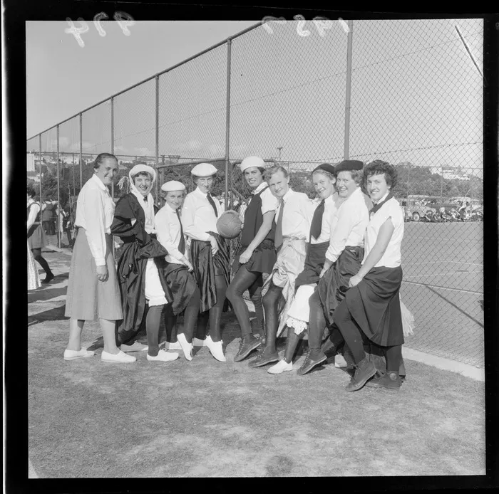 Netball team in unconventional uniform posing at the Hataitai courts, Wellington