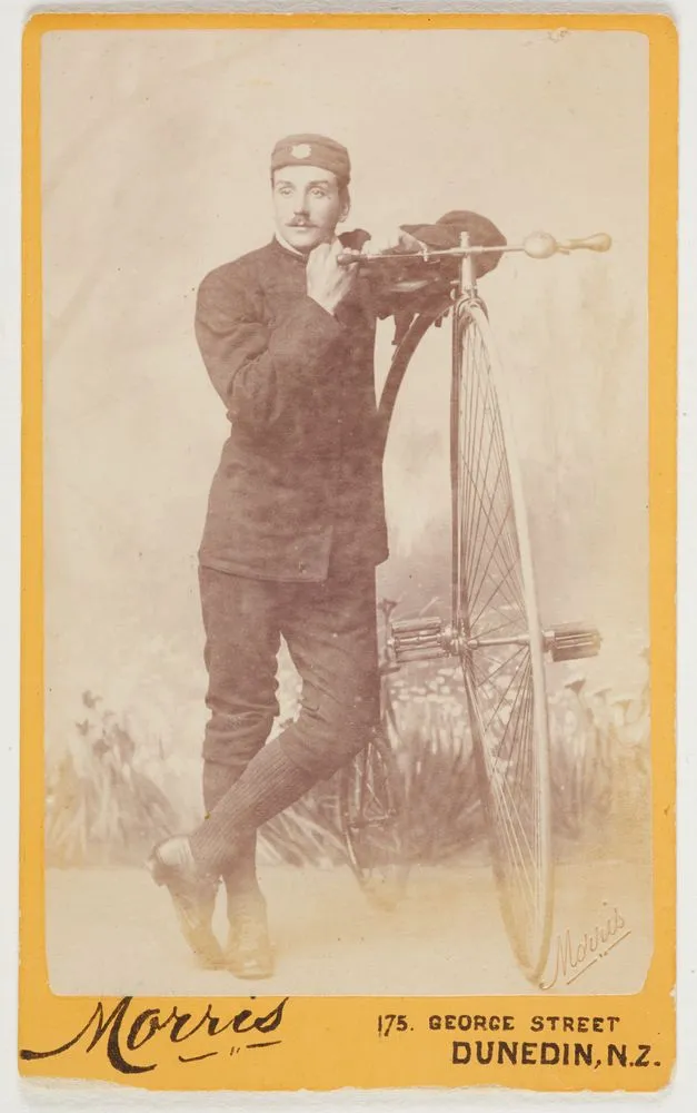 Man with penny-farthing bicycle