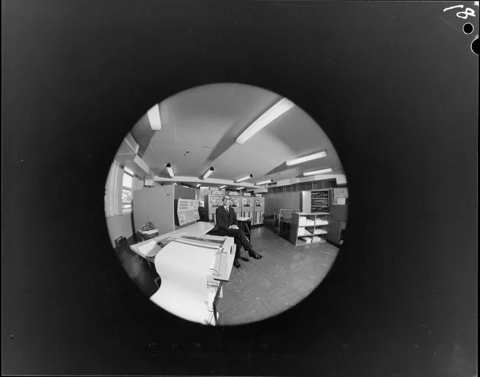 Fish-eye portrait of man with computers