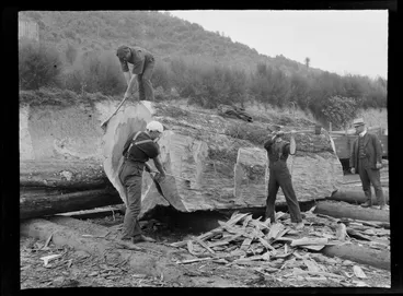 Image: William Williams observing three unidentified men trimming a large tree trunk with axes prior to it going to the sawmill, Kakahi Settlement, Manawatu-Whanganui Region