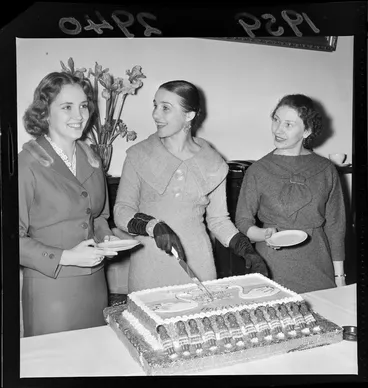 Image: Group of unidentified women cutting cake decorated with Maori dolls at Bolshoi Ballet at Russian Legation, probably Wellington region
