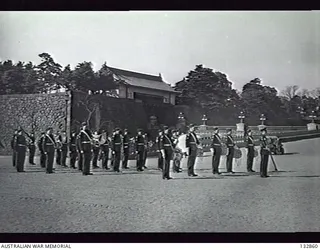 TOKYO, JAPAN. 1947-02-04. 2ND NEW ZEALAND EXPEDITIONARY FORCE REGIMENTAL BAND BCOF READY FOR GUARD CHANGE OUTSIDE THE IMPERIAL PALACE ENTRANCE