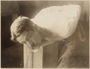 Image: Man with his head on chopping block