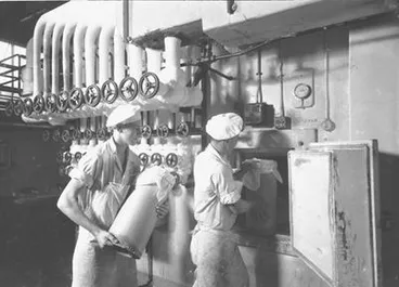 Image: [Loading canisters into fridge]