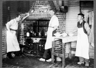 Image: Waitaki Farmers' Freezing Company, Pukeuri, early 1920s. Three gentlemen with aprons on in front of range cooking