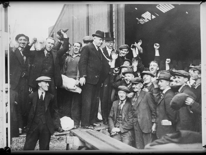 New Zealand Prime Minister Peter Fraser during a visit to England, with Lord Mayor and dockers unloading New Zealand lamb