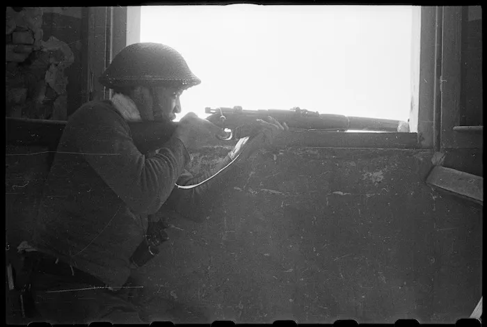Private J Wyllie from 28 (Maori) Battalion sniping at the enemy in the Senio River area, Italy - Photograph taken by J Short