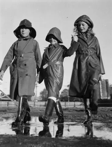 Image: Three children dressed in wet weather clothes