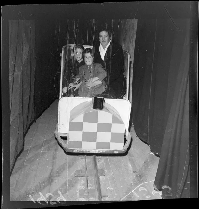 Unidentified mother and children at an Industrial Fair sideshow [Wellington?]
