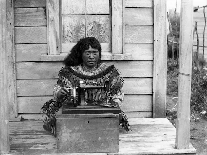 Woman with sewing machine, Taranaki district