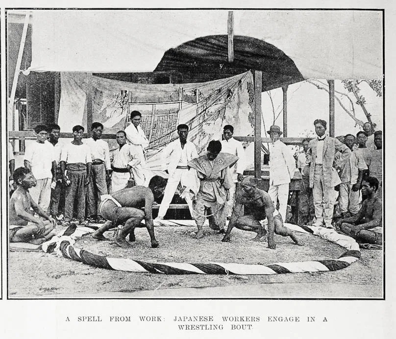 A spell from work: Japanese workers engage in a wrestling bout