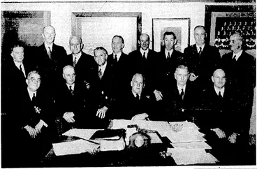 Image: Evening Post" Photo; Members of the New Zealand Rugby Council in session at, Wellington yesterday. In front, from left, Dr. G. J. Adams (Wanganui), Messrs. R.T. Meredith (Southland), president of the N.Z.R.U,, G. A. Maddison (Haivke's Bay), S. S. Dean (chairman), A. E. Neilson (secretary), and D. M. Spedding (Otago). At back, Mr. A. C. Kitto, Lieut.-Col. J.G. Roache, Messrs. F. T. Glasgow (all of the N.Z.R:U. executive), A. E. McPhail (Canterbury),W. J. Wallace, A. McDonald (executive-members), A. A..Adams (West • ~ . Coast), and J. Prendeville (executive member). Absent, Mr. A. St.- C. Belcher (Waikato). (Evening Post, 11 December 1937)