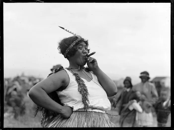 Wahine smoking a cigar, location unidentified