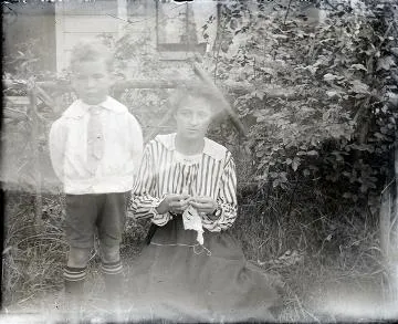 Woman with a young boy : photograph