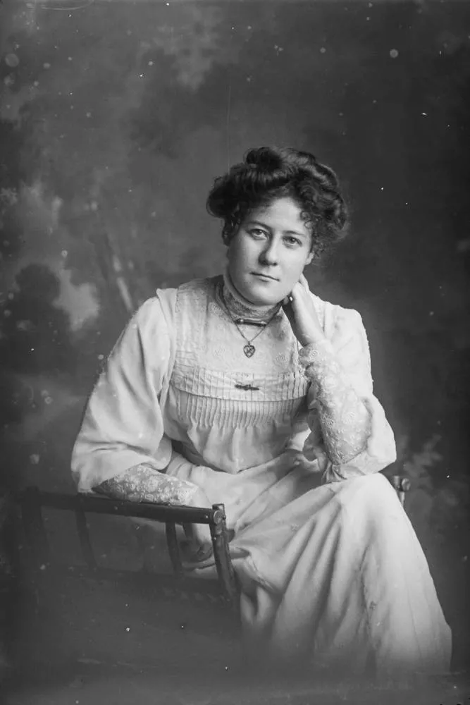 Miss Swanson leaning her left elbow on books, 1909