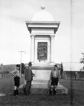 Frederick Daniell and two boys at the Mahupuku Monument