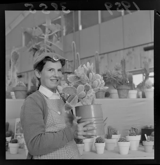 Hutt Valley Horticultural Show, unidentified young girl holding a cactus with other cacti and succulents behind, Wellington Region