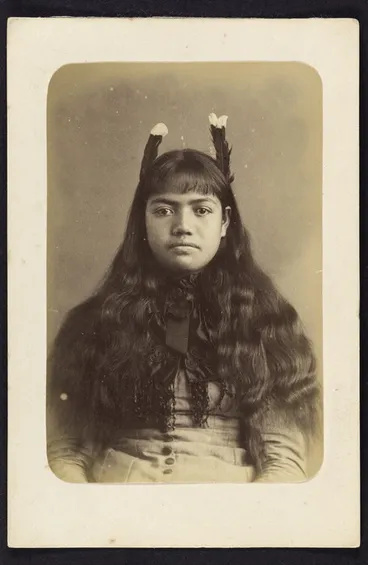 Image: Photographer unknown: Portrait of female Māori subject wearing two huia feathers