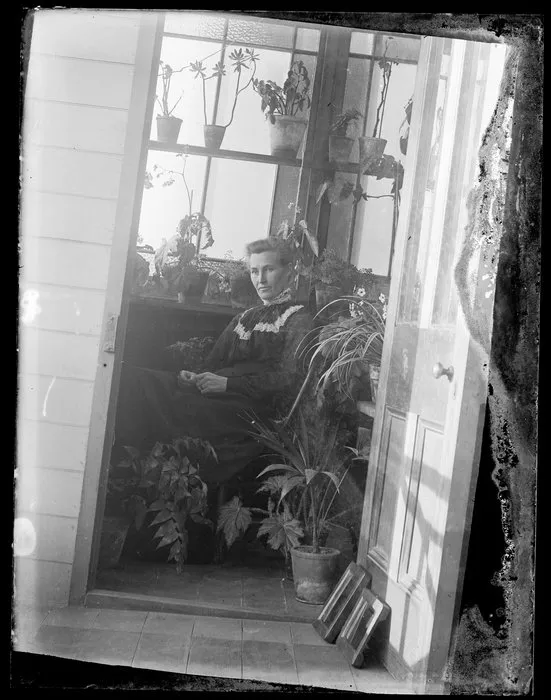 Robina Nicol seated in glazed verandah