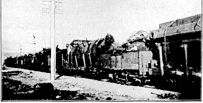 Evening Post" Photo. MORE SCRAP FOR JAPAN.—Forsome months past a special gang has been collecting up railway junk from the old Petone yards and in taking down old locomotives at Woburn. The photograph show! some.of the trucks of scrap lined-up waking fpr the arrival pj[the junk ship. . (Evening Post, 18 October 1933)