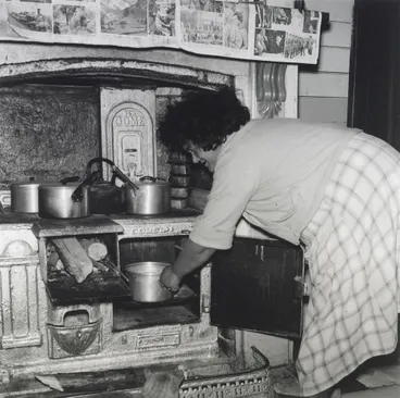 Image: Mrs Wereta stokes the fire. She has made dough... From the series: Washday at the pa