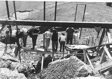 Image: Clock makers looking out at the hands as they were installed.