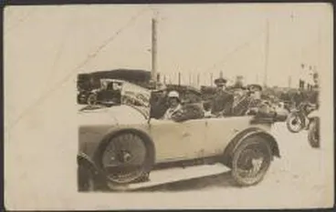 Image: Charles Ulm and Charles Kingsford Smith, being driven in an open car with the official reception party, Christchurch, New Zealand, 1928