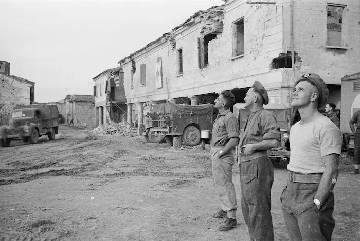 World War II soldiers from New Zealand, in a forward area near Gambettola, Italy, watching Allied planes dive bombing and strafing enemy positions - Photograph taken by George Kaye