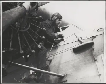 Image: Charles Ulm climbing out of the cockpit of Fokker F.VIIb/3m, VH-USU, Southern Cross, 1928 [picture].