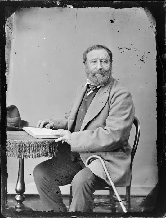 Unidentified man, seated, with an open book