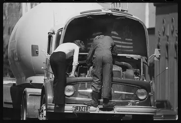 Image: Men working on the engine of a Mercedes tanker