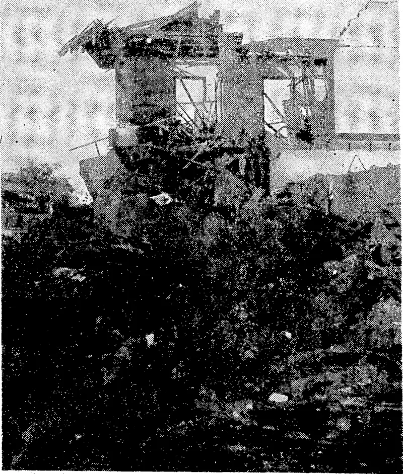 One of the buildings on the main street of Darwin wrecked by Japanese dive-bombers in the first raid on Australia on February 19. '■ The crater in the foreground ivas about. 12ft deep. (Evening Post, 16 March 1942)