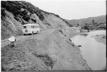 Image: School bus on a road beside the Wainui Stream