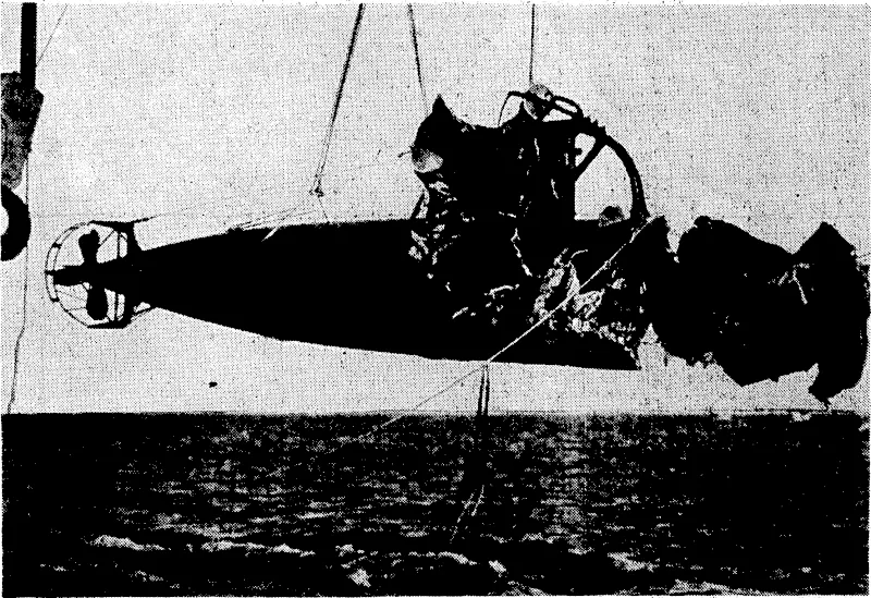 The second Japanese submarine which was raised from Sydney Harbour being moved by the giant floating crane. The stern half was intact, but the, forward portion was blown:to pieces-by an.explosion. The. naval experts who are examining the two submarines now < have the undamaged portion of ■ ttye 'first submarine (the bow) and the undamaged stern of. the second for'reconstruction..' (Evening Post, 12 June 1942)