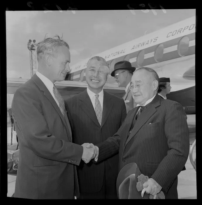 Mr Holloway greeting Mr S Yoshida former Minister of Japan and an unidentified [Japanese Consulate Official?] in front of an NZ NAC aeroplane, Wellington Airport