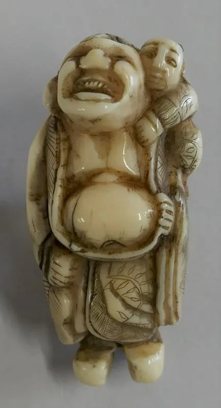 Netsuke: Hotei to wahabe [the god hotei and a child]