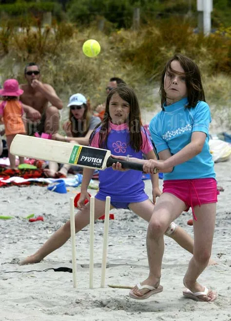 Children playing beach cricket