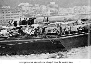 Image: A barge-load of wrecked cars salvaged from the sunken ferry